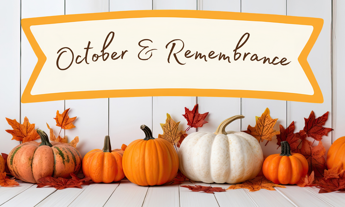 A row of small orange pumpkins with a single white pumpkin in the middle with fall leaves around the pumpkins. All of this below a banner that reads "October & Remembrance".