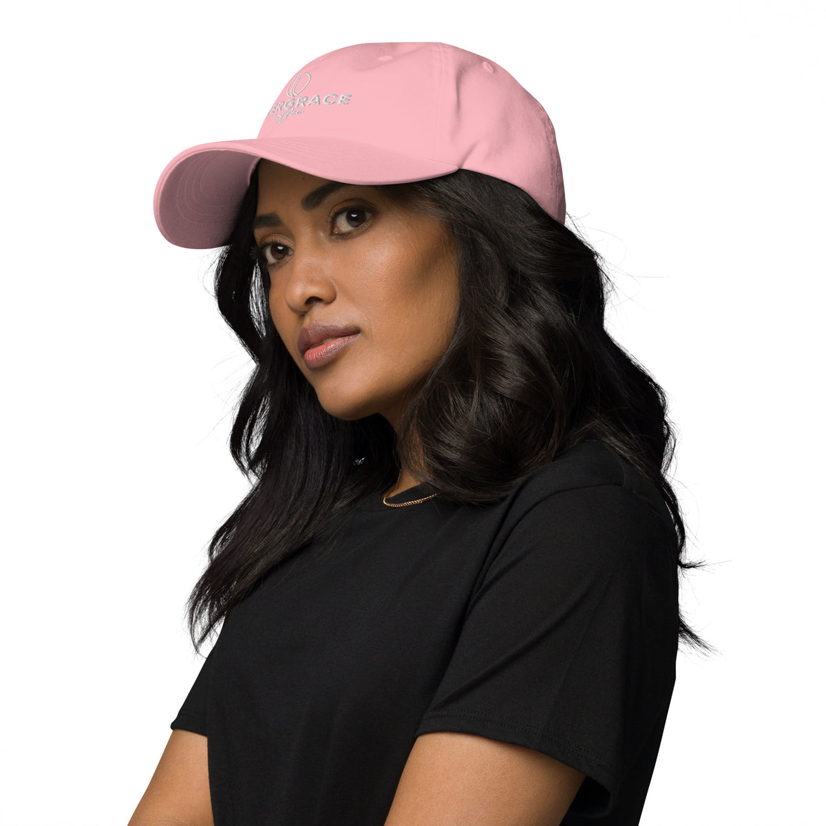Woman wearing a pink EverGrace Coffee cap with a small logo on a white background